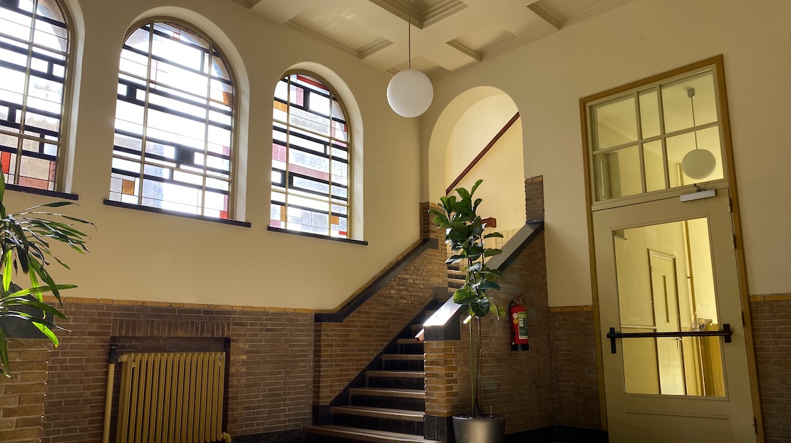 Staircase with stained glass windows in dorm building