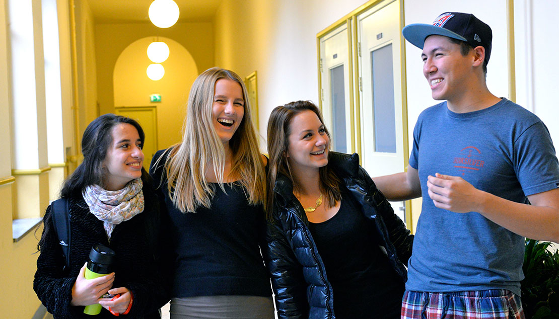 Students talking and laughing in the hallway in the dormitory