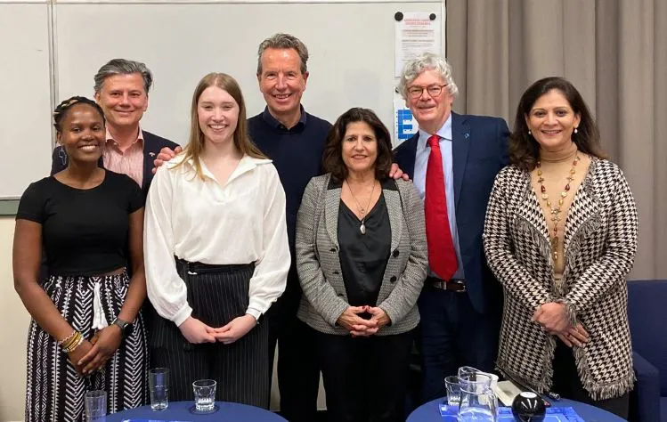 Webster Leiden faculty members and International Relations Club members at a political cafe event about the "Future of America."