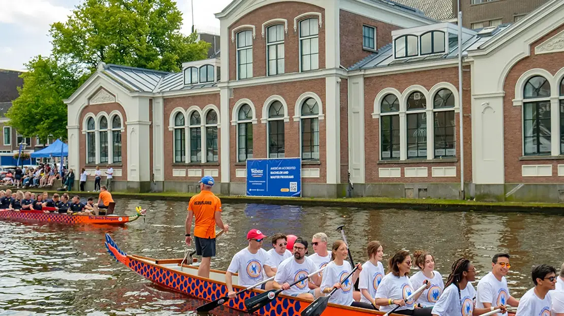 Alumni during dragonboat races in the canal.